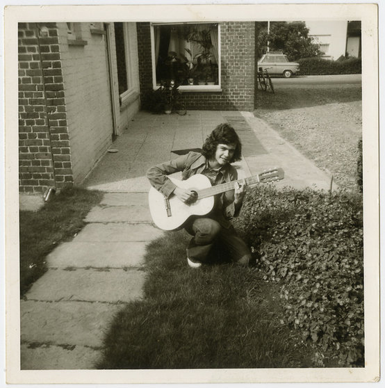 Jongen-met-gitaar-in-tuin-ca-1973